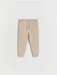 Dresowe spodnie typu jogger, wykonane z gładkiej, bawełnianej dzianiny. - beżowy