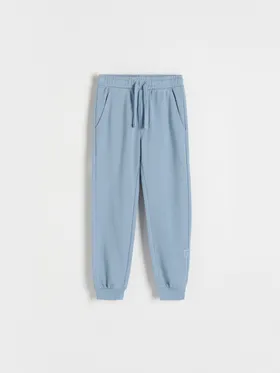 Dresowe spodnie typu jogger, wykonane z gładkiej, bawełnianej dzianiny. - niebieski