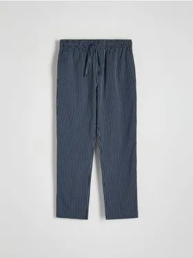 Spodnie piżamowe o swobodnym fasonie, wykonane z bawełnianej tkaniny. - granatowy