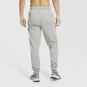 Męskie spodnie treningowe o zwężanym kroju Nike Dri-FIT - Szary