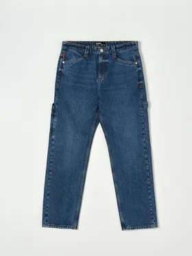 Spodnie jeansowe o kroju loose z modnymi przetarciami, uszyte z bawełny. - niebieski