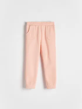 Spodnie typu jogger, wykonane z melanżowej dzianiny z bawełną. - koralowy