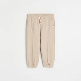 Dresowe spodnie z przeszyciami - Kremowy