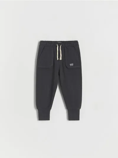 Reserved Dresowe spodnie typu jogger, wykonane z gładkiej, bawełnianej dzianiny. - ciemnoszary