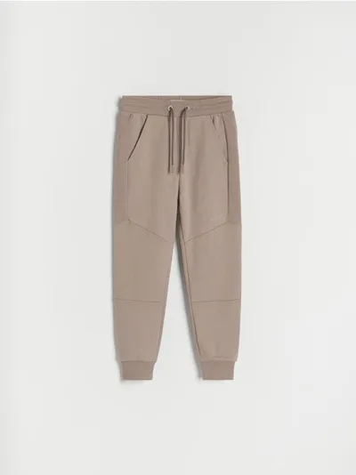Reserved Spodnie typu jogger, wykonane z dresowej, bawełnianej dzianiny. - beżowy