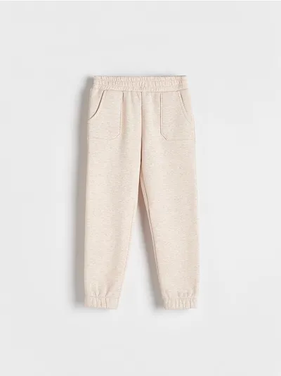 Reserved Spodnie typu jogger, wykonane z melanżowej dzianiny z bawełną. - beżowy