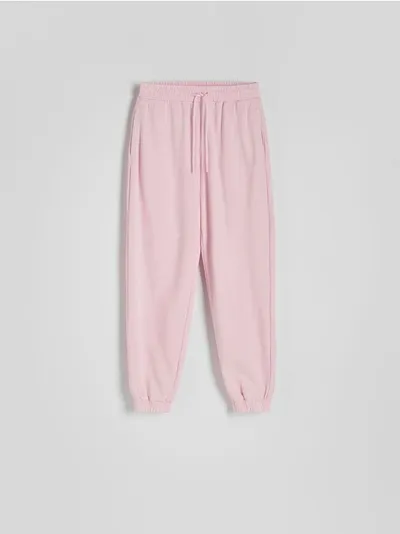 Reserved Spodnie o swobodnym fasonie, wykonane z bawełnianej dzianiny. - pastelowy róż