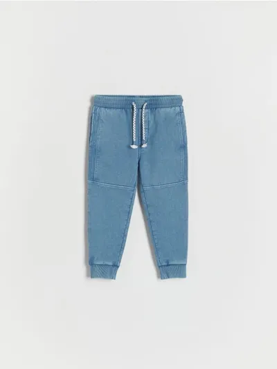 Reserved Dresowe spodnie typu jogger, wykonane z gładkiej, bawełnianej dzianiny. - niebieski