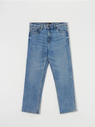 Sinsay Spodnie jeansowe o kroju loose fit z modnymi przetarciami, uszyte z bawełny. - niebieski