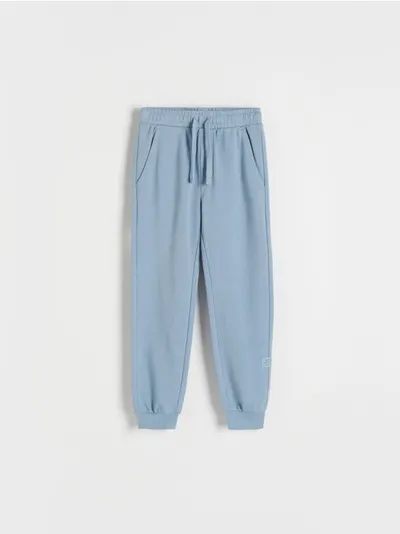 Reserved Dresowe spodnie typu jogger, wykonane z gładkiej, bawełnianej dzianiny. - niebieski