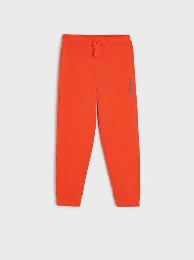 Sinsay Spodnie dresowe jogger wykonane z miękkiej dzianiny. - pomarańczowy