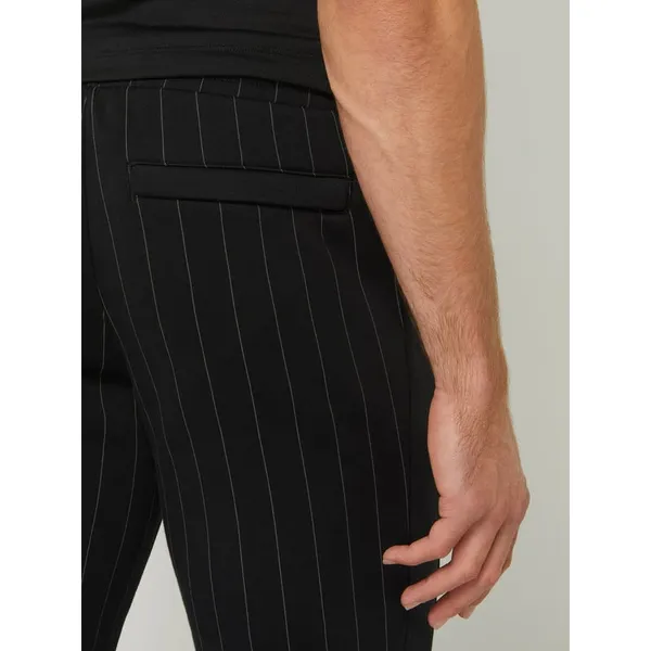 PUMA PERFORMANCE Spodnie dresowe ze wzorem w cienkie prążki