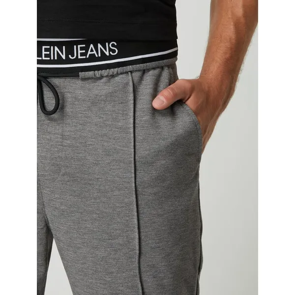Calvin Klein Jeans Spodnie sportowe o kroju slim fit z paskiem z logo