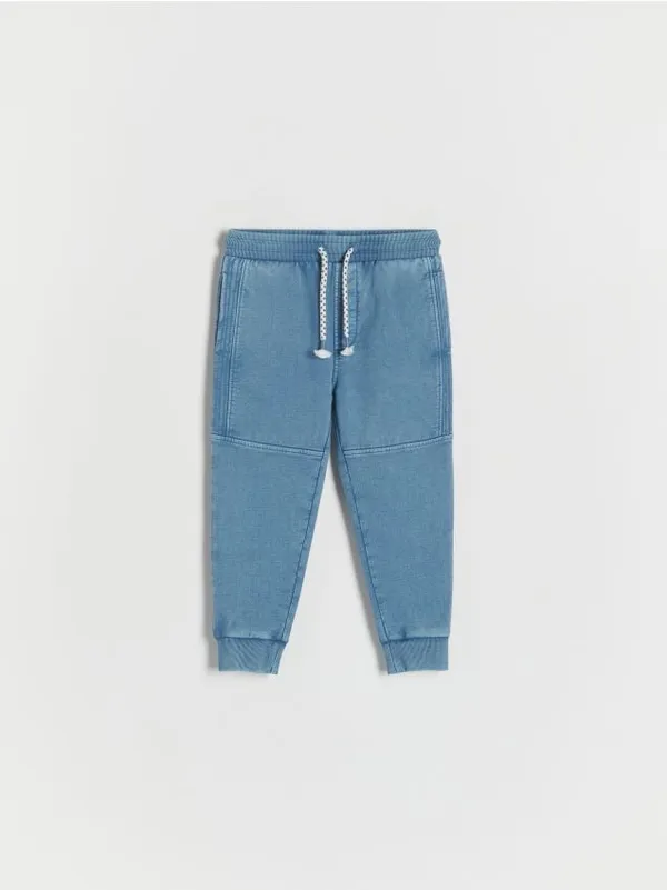 Dresowe spodnie typu jogger, wykonane z gładkiej, bawełnianej dzianiny. - niebieski