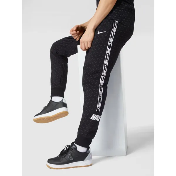 Nike Spodnie dresowe z detalami z logo