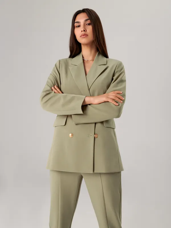 Eleganckie spodnie ze złotymi guzikami, uszyte z materiału z dodatkiem elastycznych włókien. - zielony