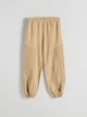 Spodnie o swobodnym fasonie, wykonane z bawełnianej tkaniny. - beżowy