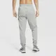 Męskie spodnie treningowe o zwężanym kroju Nike Dri-FIT - Szary
