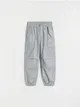 Spodnie typu parachute, wykonane z bawełnianej tkaniny. - srebrny